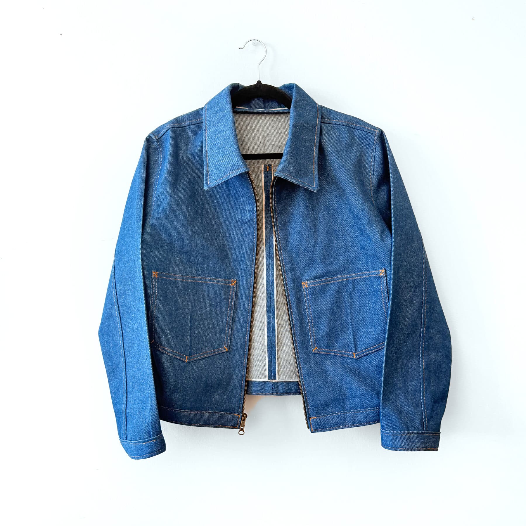 The whole garment, front, open on the hanger